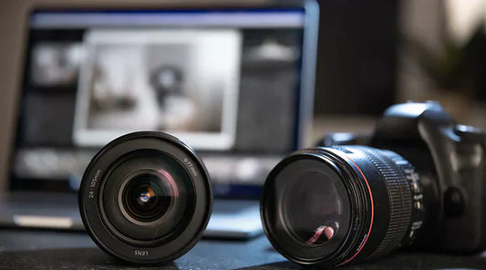Digital camera lenses displayed on counter at PayMore Kennesaw